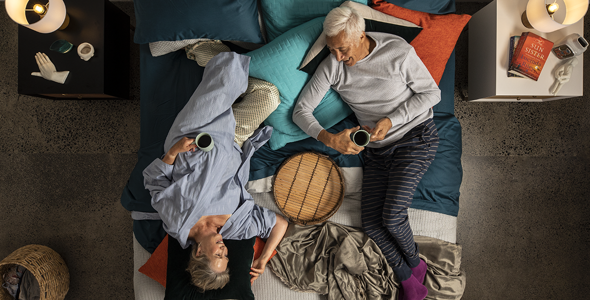 old couple lying on bed
